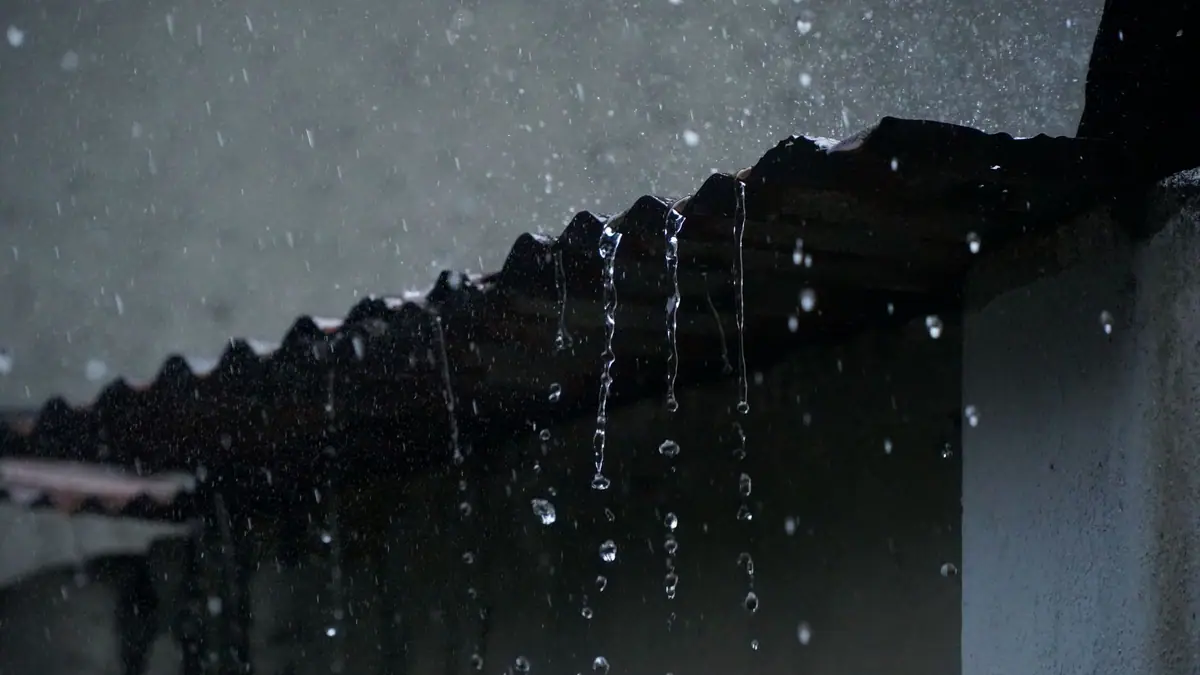 Rain running off the edge of a corrugated roof